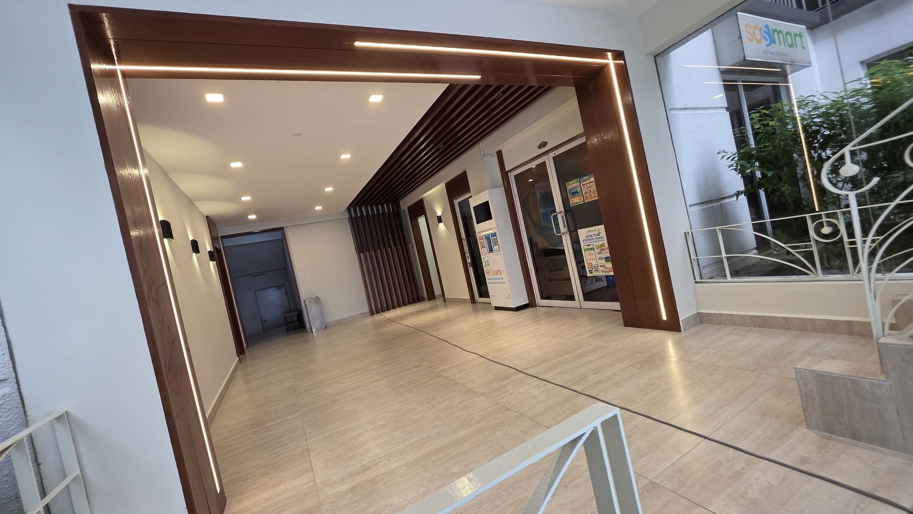 Timber portal frame and fluted fins in a condominium lobby